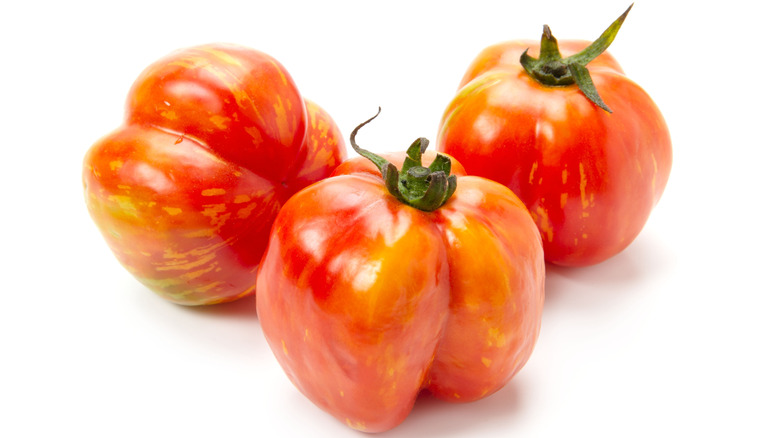 Striped Cavern tomatoes on white background