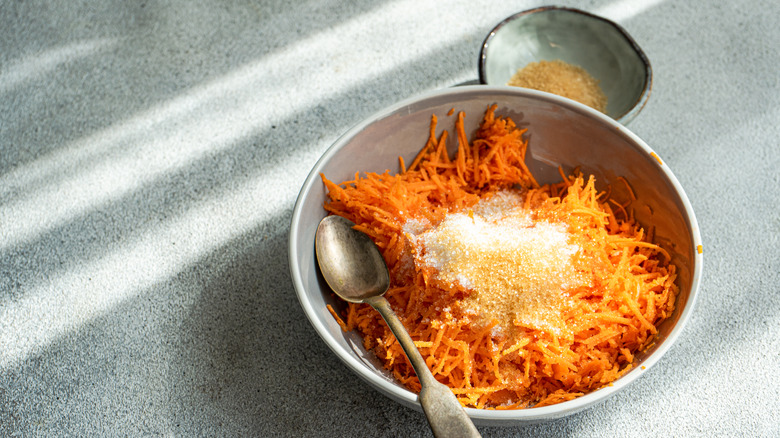 Bowl of shredded carrots with sugar