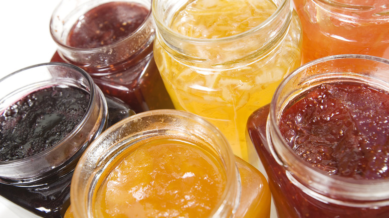 a selection of jams and jellies in jars