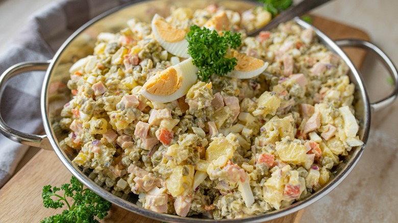 Large metal bowl of Russian egg salad with ham