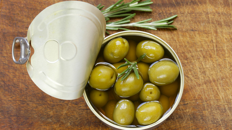 Overhead view of opened can of green olives