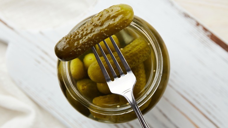 Overhead view of a jar of pickles with fork resting on top