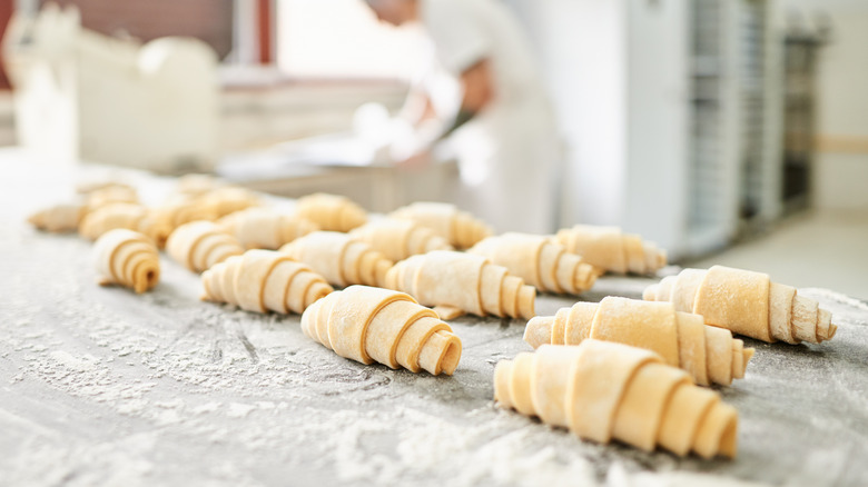 unbaked croissants on kitchen surface