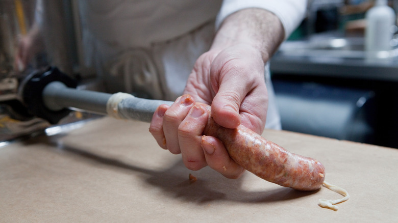 butcher stuffing sausage casing