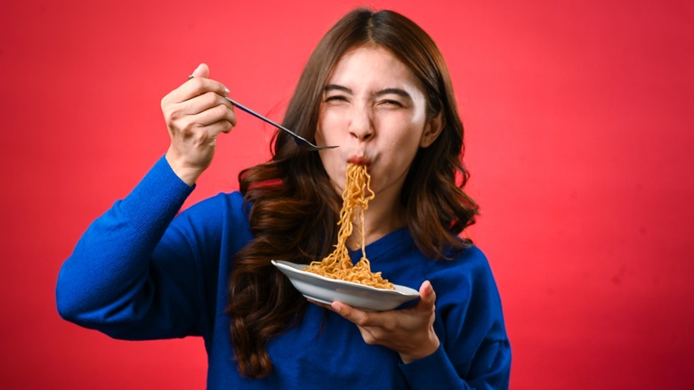 Woman slurping Asian noodles