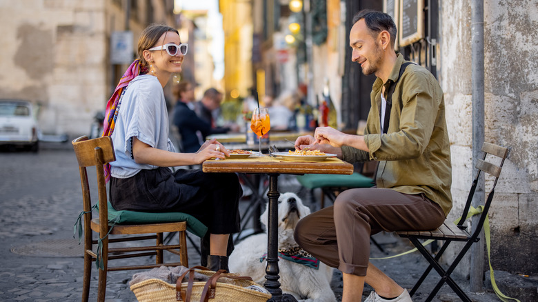 Man and woman eating at an outdoor cafe table