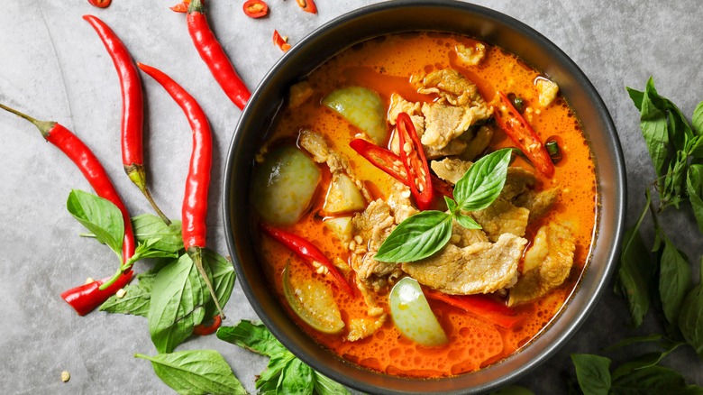 Bowl of Thai curry with spicy peppers and Thai basil