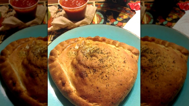 Costco calzone on plate with marinara sauce