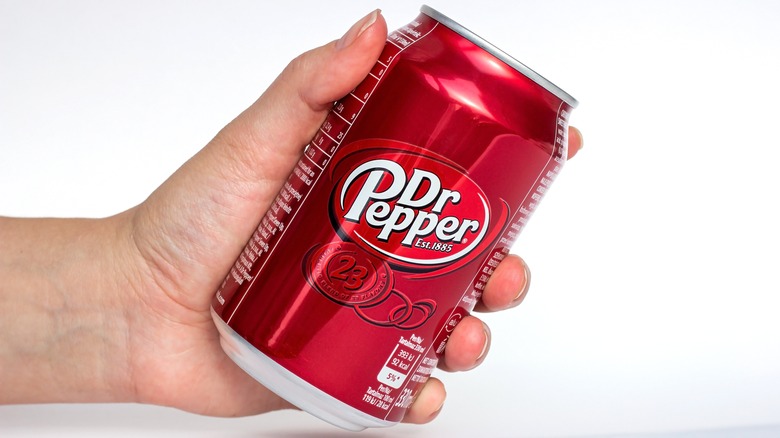 hand holding Dr. Pepper can