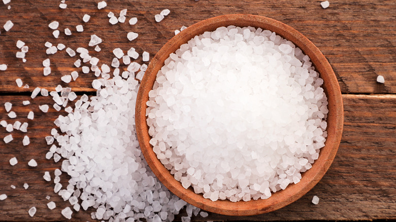 Coarse salt in wooden bowl