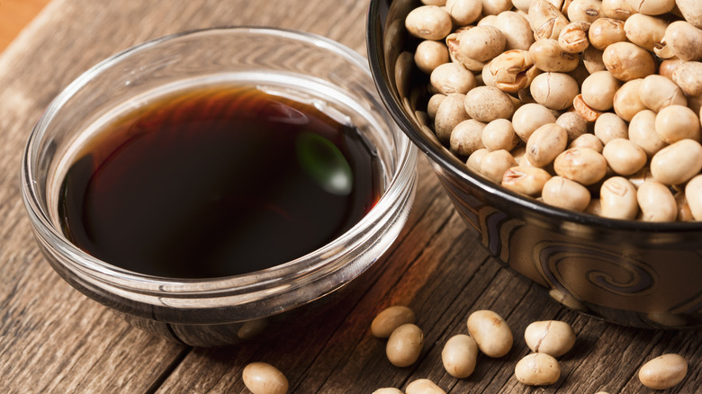soy sauce in bowl and soybeans