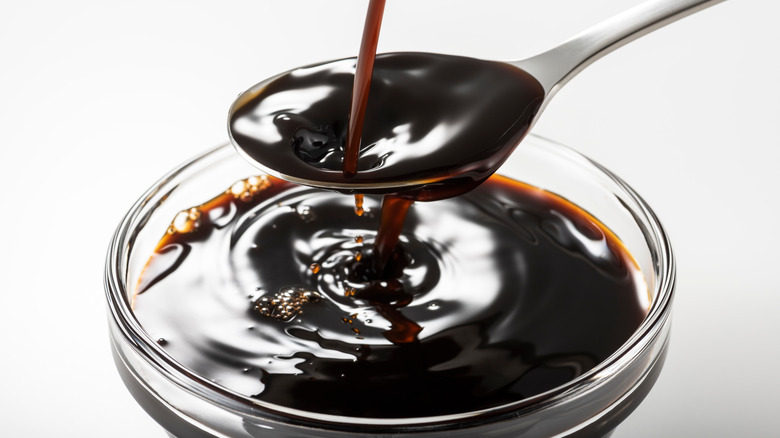 worcestershire sauce poured onto spoon and bowl