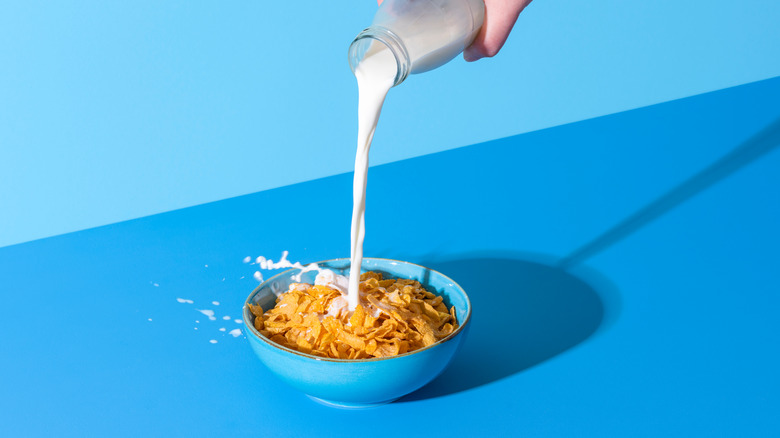 pouring milk on cereal