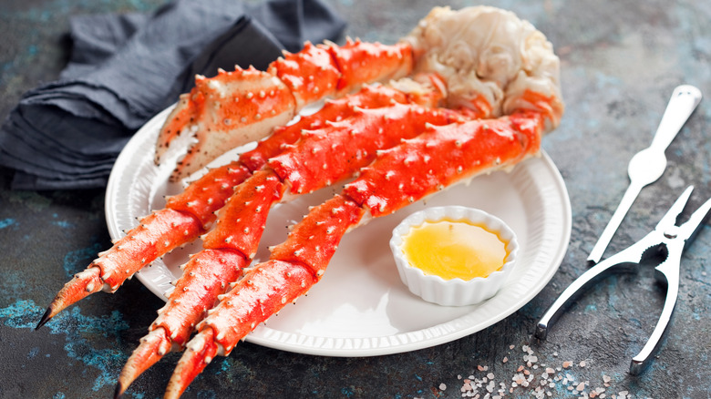 King crab legs on plate with butter sauce