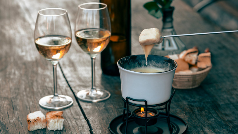 Cheese fondue with two glasses of wine