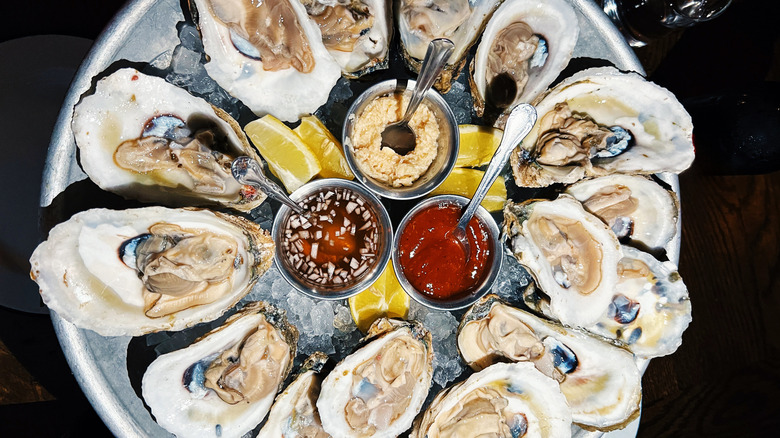 Platter of oysters with various sauces