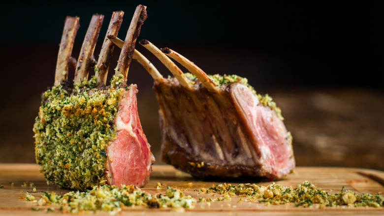 Herb-crusted rack of lamb on cutting board