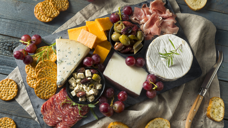 Charcuterie board with various meats and cheeses