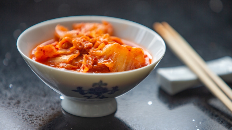 Kimchi in bowl with chopsticks