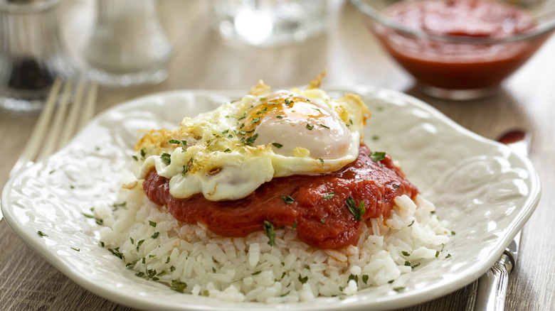 Fried egg and tomato sauce on top of rice