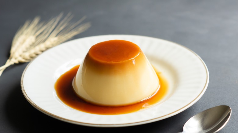 flan on white plate with spoon