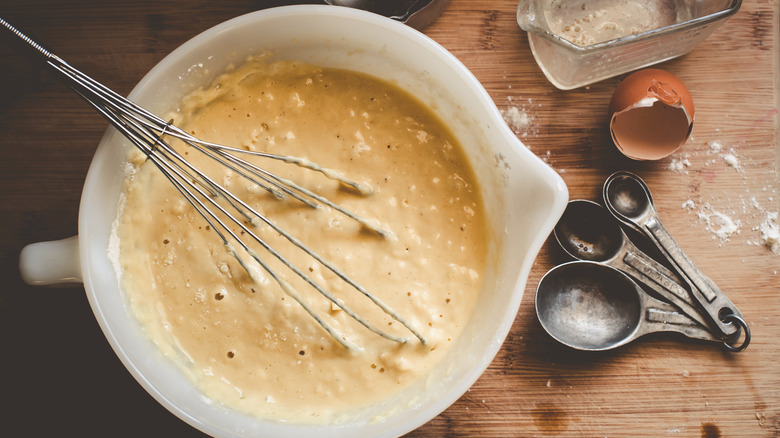 Pancake batter in a bowl with whisk