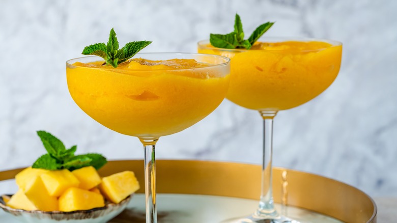 a close up of two frozen mango cocktails