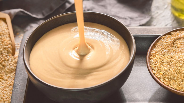 Tahini in bowl with sesame seeds