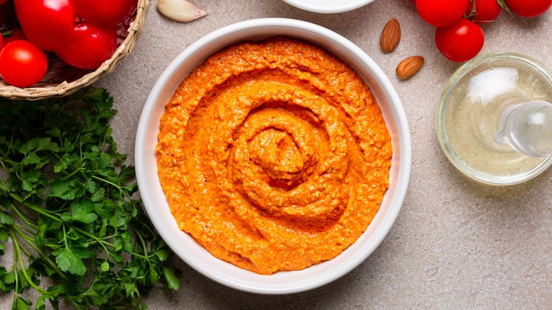 Romesco sauce in bowl with herbs