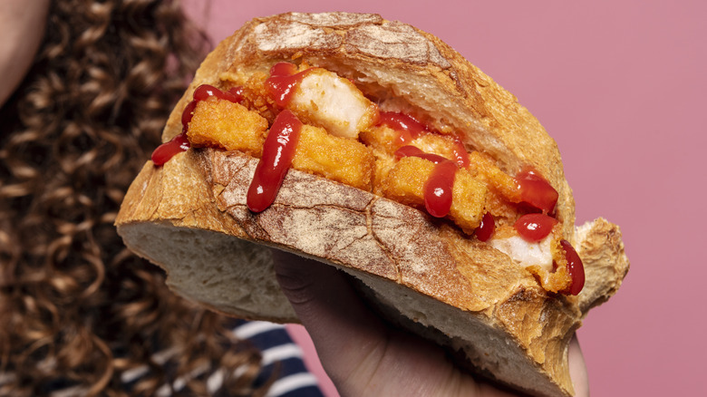 Fish fingers sandwich dripping with ketchup