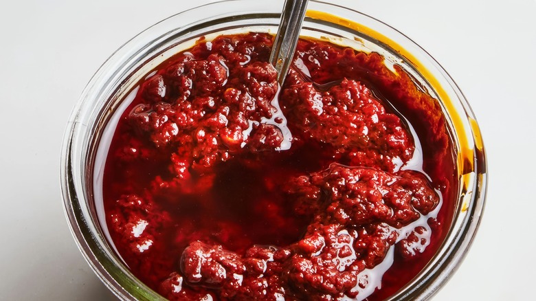 Harissa paste in jar with spoon