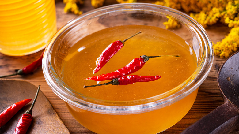 Hot honey in bowl infused with spicy peppers