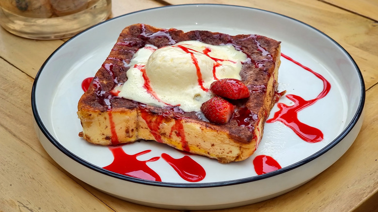 French toast with strawberries and melting vanilla ice cream on top