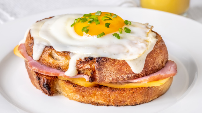 Croque madame sandwich on white plate