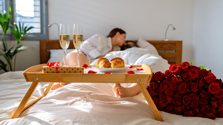 Couple sharing romantic moment with breakfast in bed