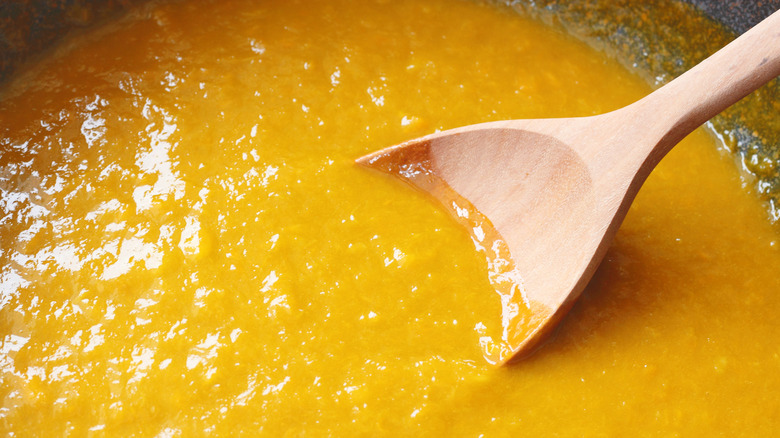 mango puree with wooden spoon