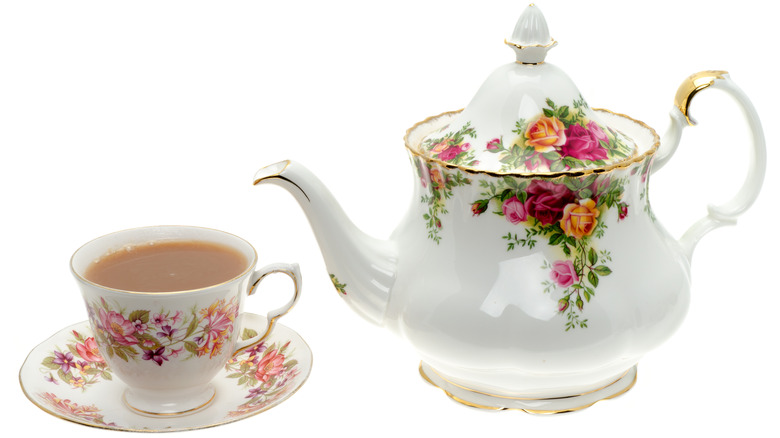 floral teapot and matching cup and saucer with tea