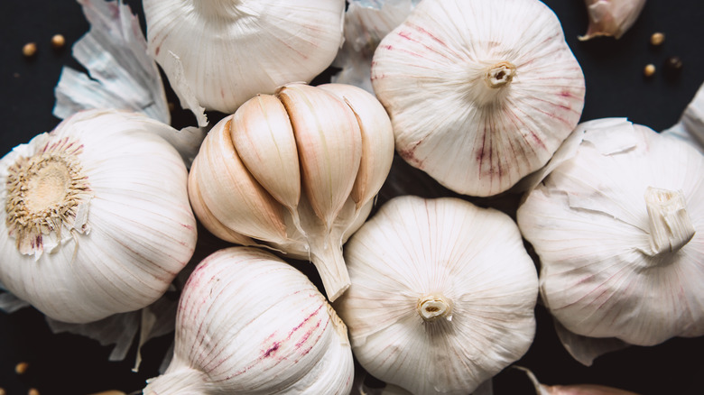 garlic cloves on black background