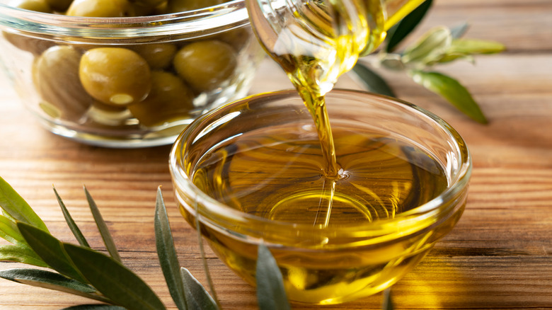 olive oil with fresh olives
