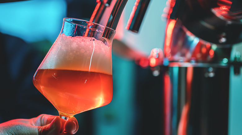 a beer being poured from a tap