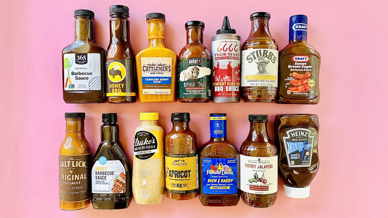 Variety of barbecue sauce bottles in rows