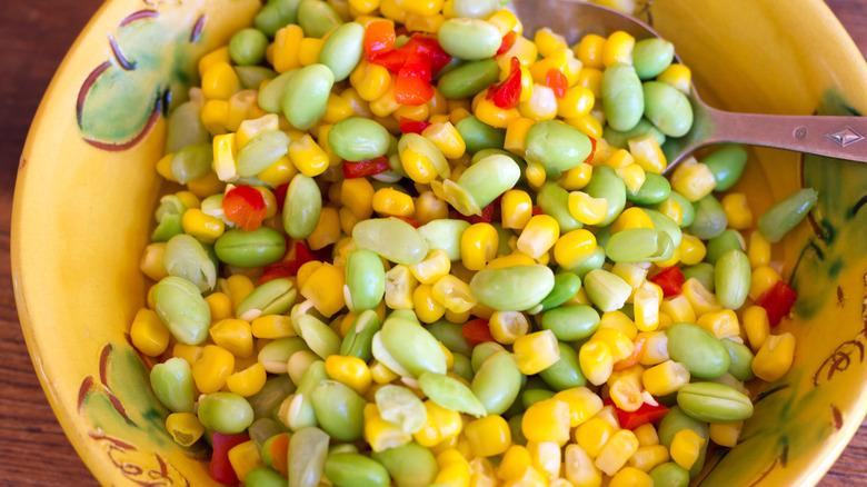 dish of succotash with spoon