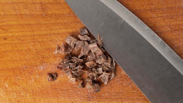 chopped anchovies on cutting board