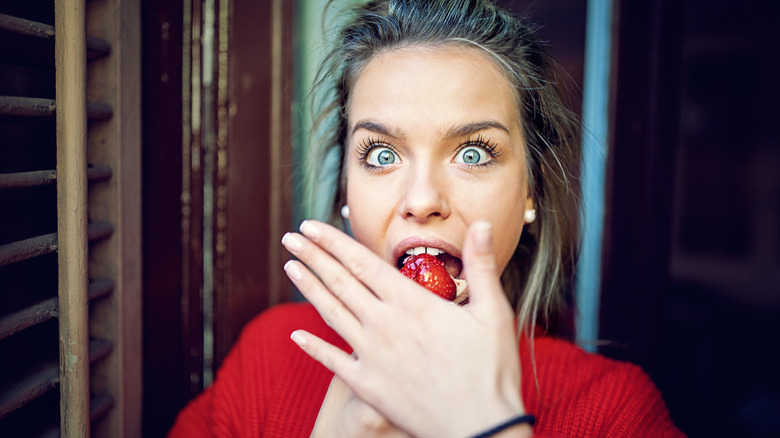 woman scared of eating strawberry