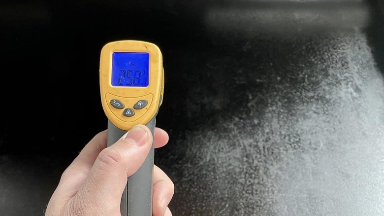 infrared thermometer checking griddle temperature