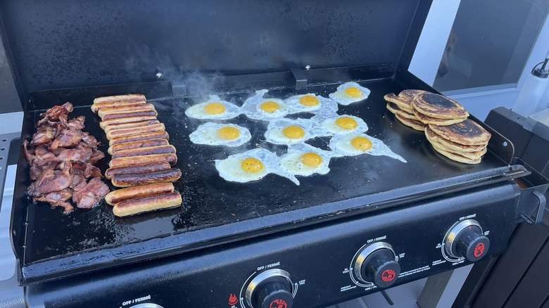 breakfast foods cooking on griddle