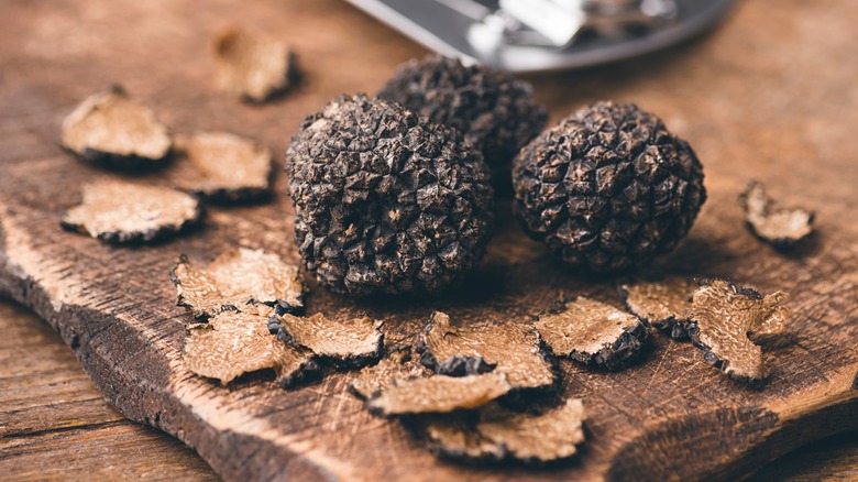 Sliced and whole black truffles