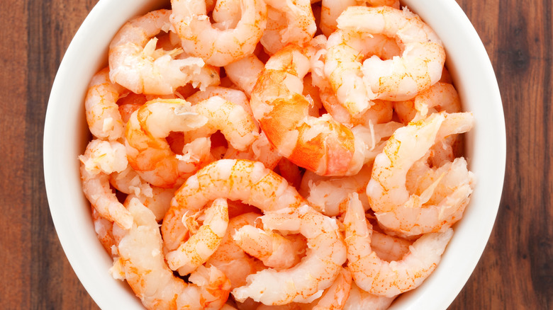 Cooked peeled shrimp in a white bowl