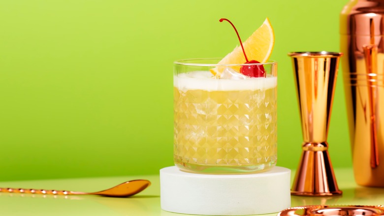 Whisky cocktail against yellow background