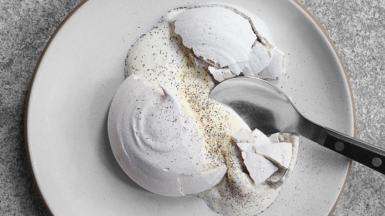 meringue and cream dessert with spoon